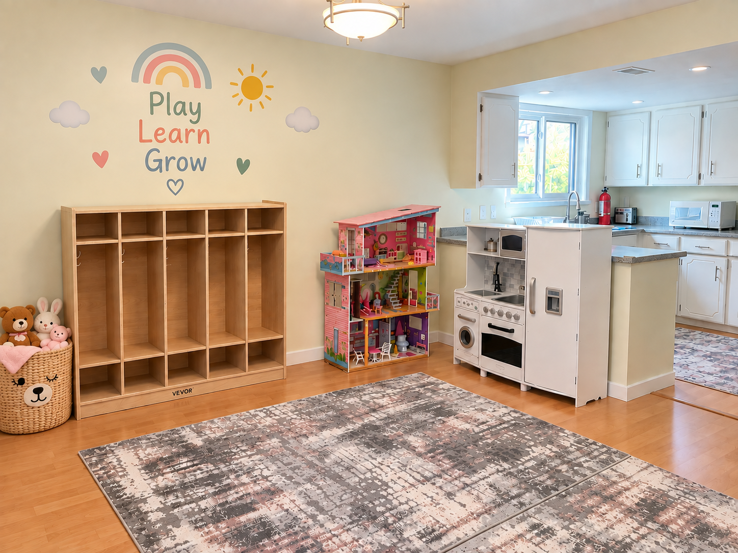 The pretend play area at Little Ocean Childcare with a play kitchen, dollhouse and cubby storage